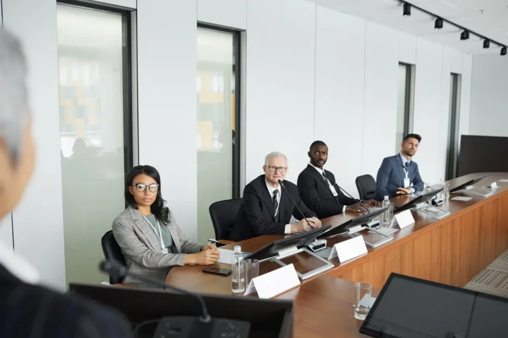 Reunião de negócios com quatro profissionais atentos.